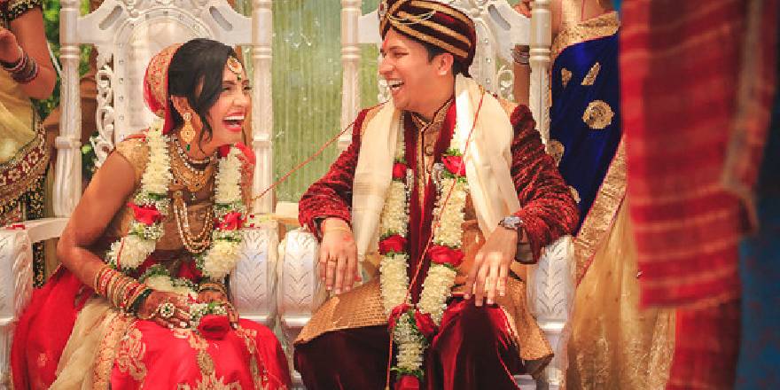 A Candid Photography of a Beautiful Bride and Groom Laughing with each other on their wedding