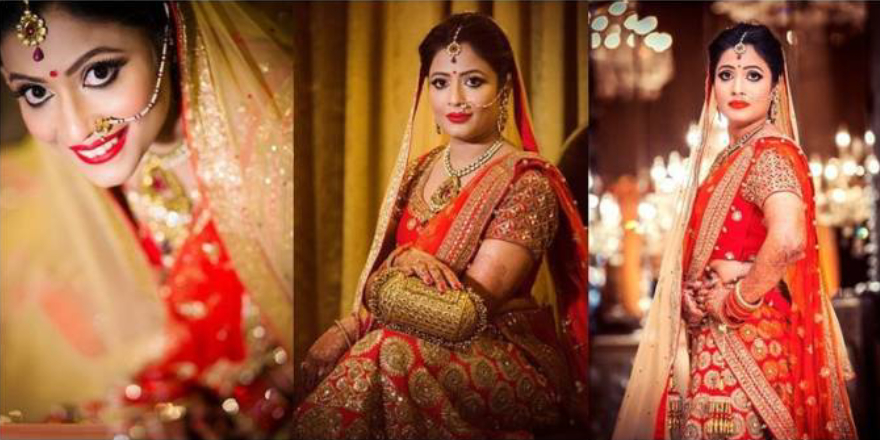 Stunning Indian Bride Dressed In Bright Red Colored Lehanga With Full Makeup And Wearing Heavy Jewellry.