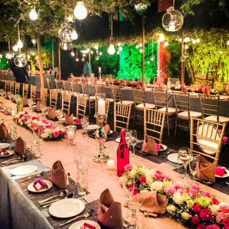 Wedding Dining Area, arch decorated with composition flowers and greenery, candles in the banquet hall. 